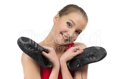 Photo of young ballerina and ballet shoes