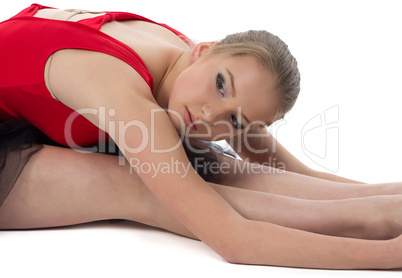 Photo of young stretching ballerina