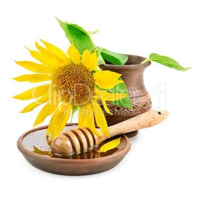 clay dish with honey drizzler and flowers sunflowers