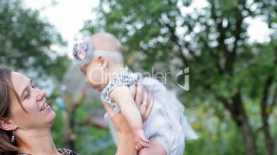 Young mother with child outside on a summer day