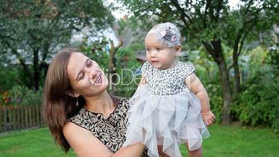 Young mother with child outside on a summer day