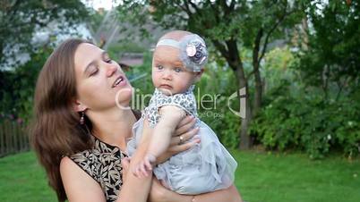 Young mother with child outside on a summer day