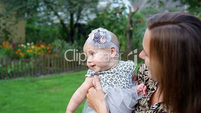 Young mother with child outside on a summer day