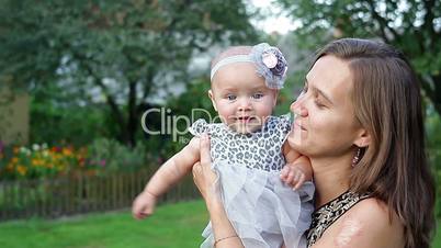 Young mother with child outside on a summer day