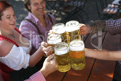 People drinking beer in a traditional Bavarian beer garden