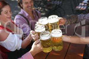 People drinking beer in a traditional Bavarian beer garden