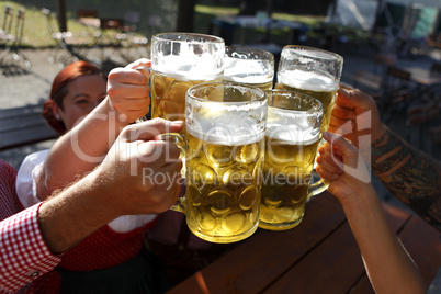 People drinking beer in a traditional Bavarian beer garden