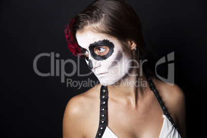 Woman with makeup of la Santa Muerte with red rose