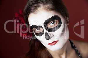 Woman with makeup of la Santa Muerte with red roses