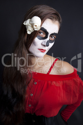 Woman with makeup of la Santa Muerte with white roses