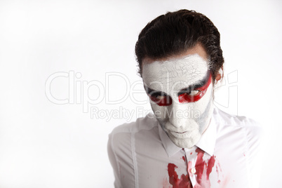 Man with white mascara and bloody shirt