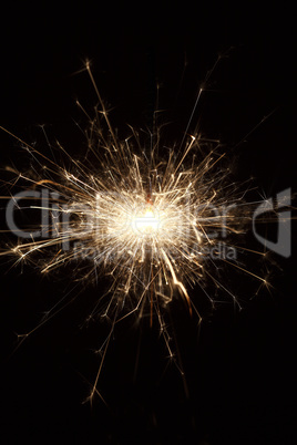 Burning sparkler on black background