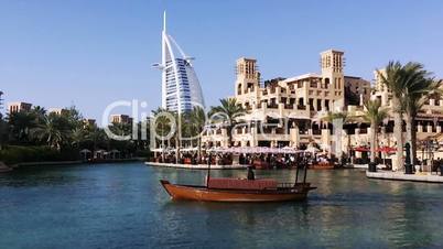 Boat moving in lake with the Burj Al Arab Hotel in background, Dubai, United Arab Emirates
