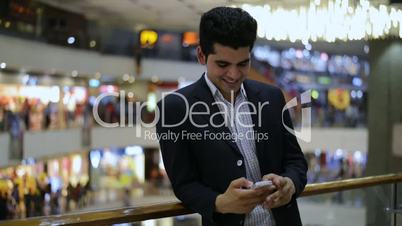 Businessman celebration his success while looking at a mobile phone
