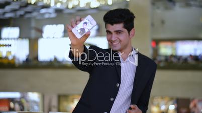 Taking picture of himself with a mobile phone