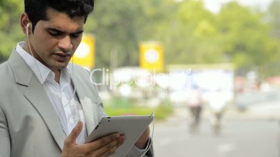 a businessman listening music on a digital tablet