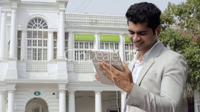 a businessman doing video calling on a digital tablet