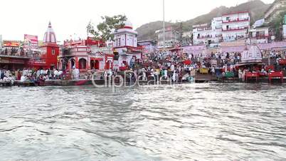 Pan shot of pilgrims at the ghat of Ganges River