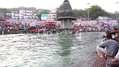 Pan shot of pilgrims at the ghat of Ganges River