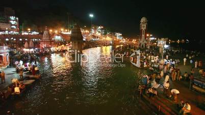 Pan shot of pilgrims at the ghats of Ganges River