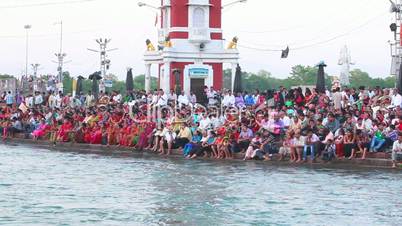 Pan shot of pilgrims at the ghat of Ganges River