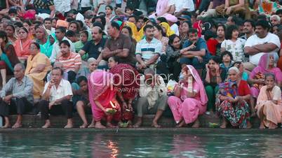 Locked-on shot of pilgrims at the ghat of Ganges River