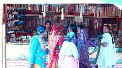 Pan shot of women shopping at a market stall