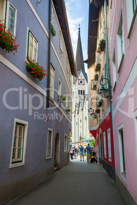 Typical street with tourists in front of the Halstatt village ch
