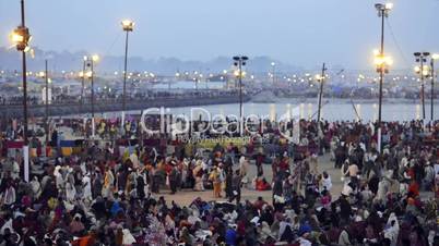 Time lapse shot of Hindu pilgrims at riverbank during Kumbh mela