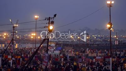 Pan shot of Hindu pilgrims at riverbank during Kumbh mela