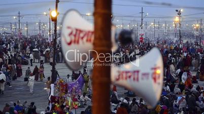 Pan shot of Hindu pilgrims at riverbank during Kumbh mela