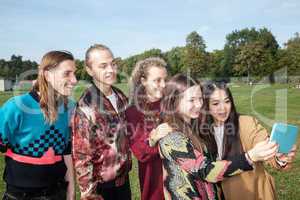 Adults young people look at the park on tablet computer