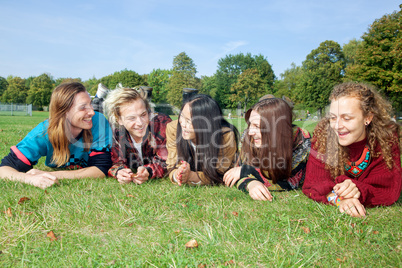 Group of young people lying in the park