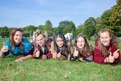 Group of young people lying in the park