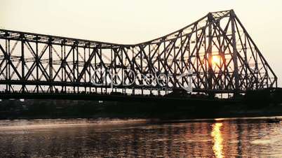 Time lapse shot of the Howrah Bridge over Hooghly River at dusk