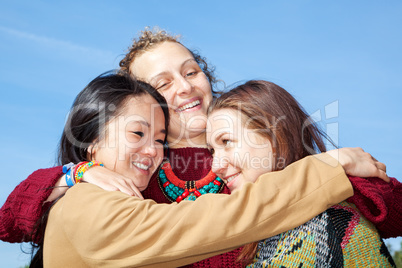 Three young women hugging each other