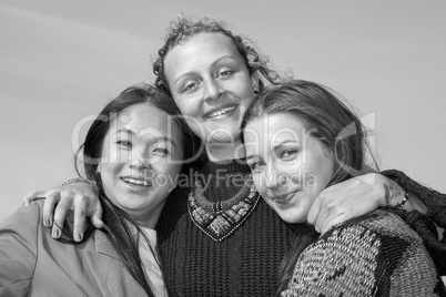 Three young women hugging each other