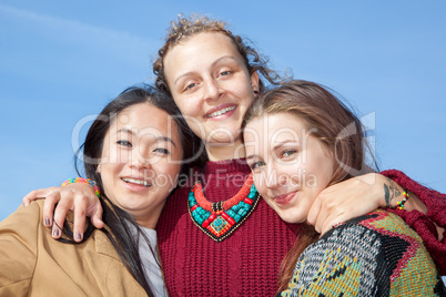 Three young women hugging each other