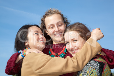 Three young women hugging each other