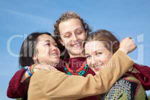Three young women hugging each other