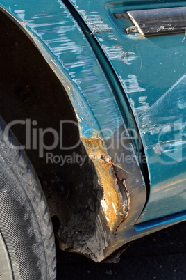 Scratched metal sheet and rust paint on a car