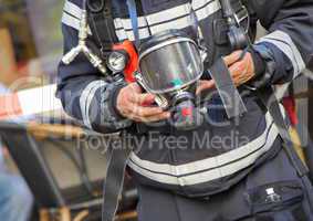 Firefighter holding oxygen or gas mask