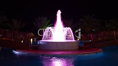 The fountain in swimming pool at luxury hotel in night illumination, Antalya, Turkey