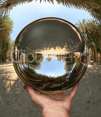 Glass sphere in hand. Vai. Crete