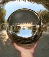 Glass sphere in hand. Vai. Crete