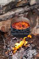 Borscht (Ukrainian soup) cooking on campfire