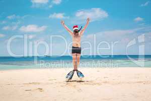 Man in santa hat on the tropical beach