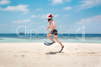 Man in santa hat on the tropical beach