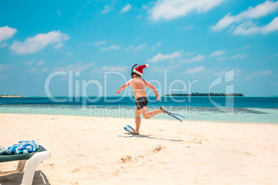 Man in santa hat on the tropical beach