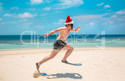 Man in santa hat on the tropical beach